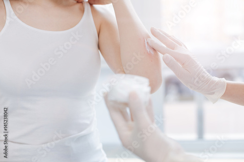 Wallpaper Mural Professional dermatologist putting medical cream on patient skin at work Torontodigital.ca