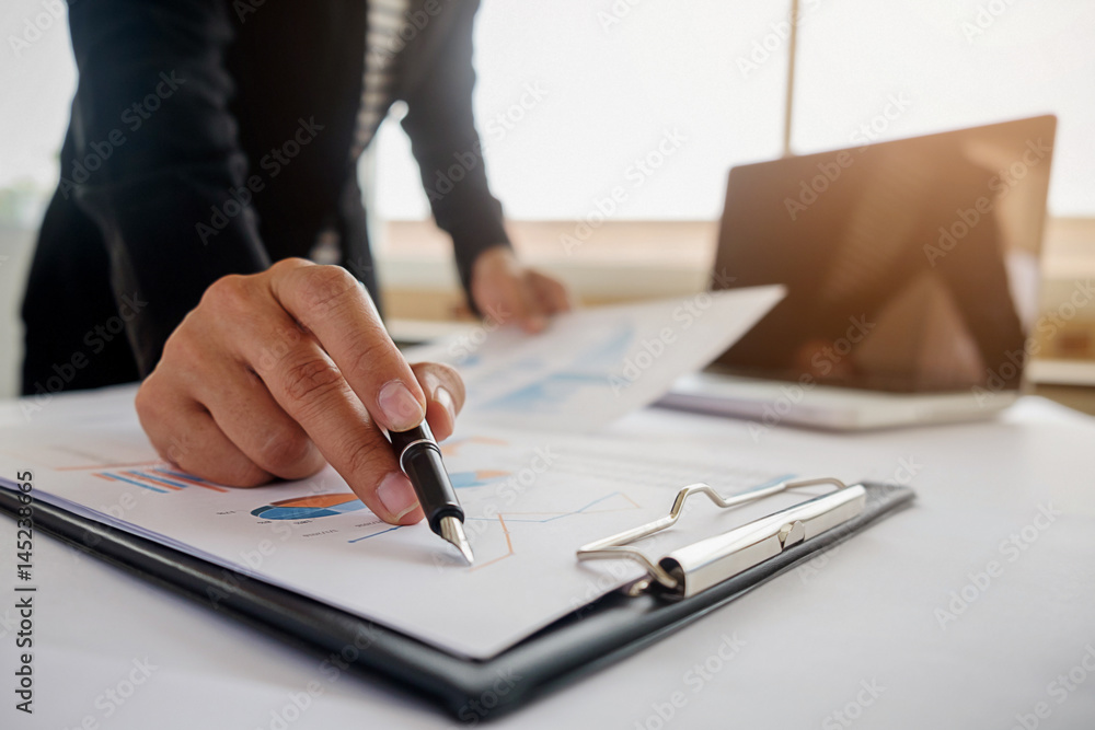 Business concept. Business people discussing the charts and graphs showing the results of their successful teamwork. Selective focus. Business concept. Business people discussing the charts and graphs showing the results of their successful teamwork. Selective focus.
