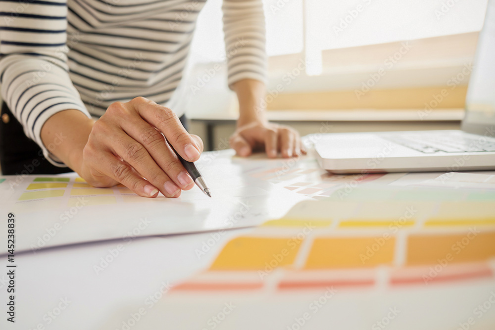 Graphic design and color swatches and pens on a desk. Architectural drawing with work tools and accessories. Graphic design and color swatches and pens on a desk. Architectural drawing with work tools and accessories.
