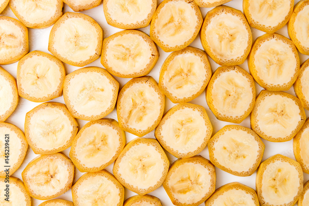 Background of sliced banana slices on white table Background of sliced banana slices on white table