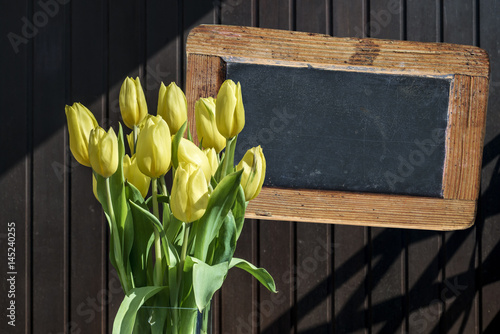 Wooden chalkboard copyspace Sign beautiful yellow tulips bucket spring flowers tulip brown background