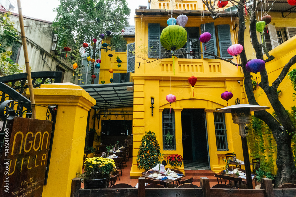 Yellow house decorated with Chinese lanterns