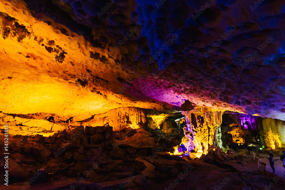 Blue and yellow light illuminates the cave