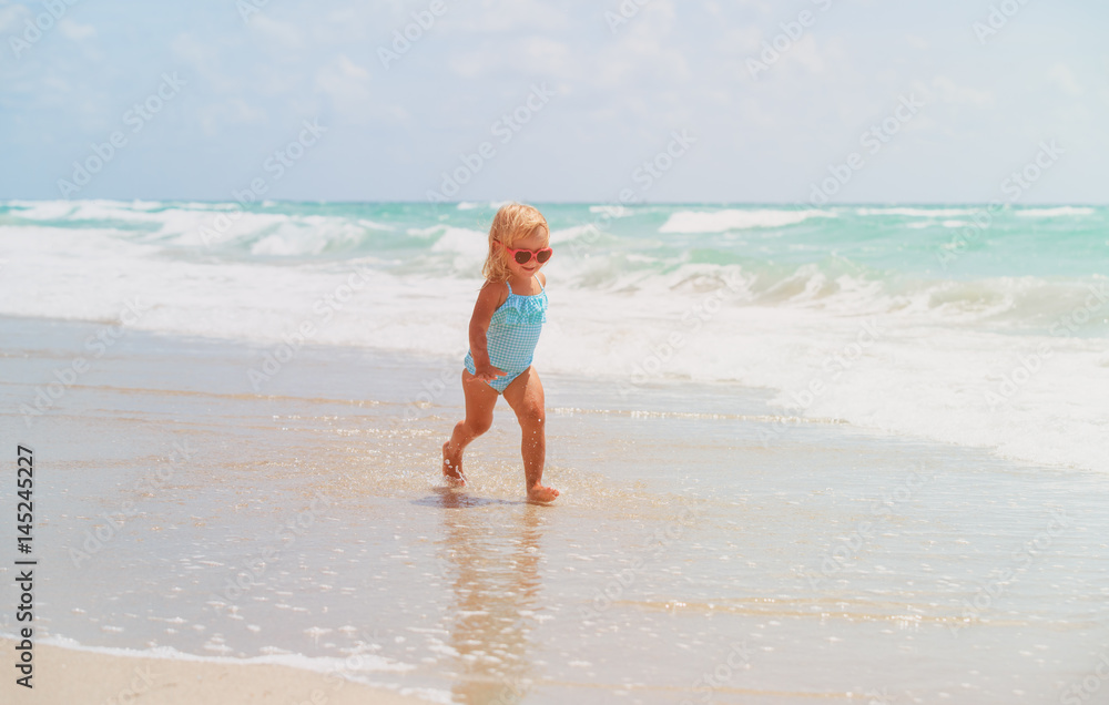 little girl run play with waves on beach little girl run play with waves on beach