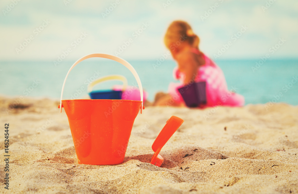 kids toys and little girl playing on beach kids toys and little girl playing on beach