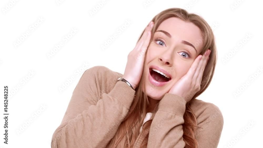 Grateful beautiful Caucasian female rejoicing from receiving surprise smiling on white background in slowmotion Grateful beautiful Caucasian female rejoicing from receiving surprise smiling on white background in slowmotion