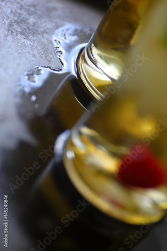Two wine cocktails on a metal tray with pool of water with room for text