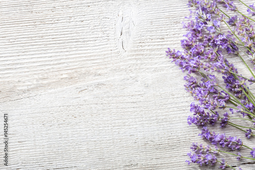 Fototapeta Naklejka Na Ścianę i Meble -  Sprigs of lavender on  wooden background