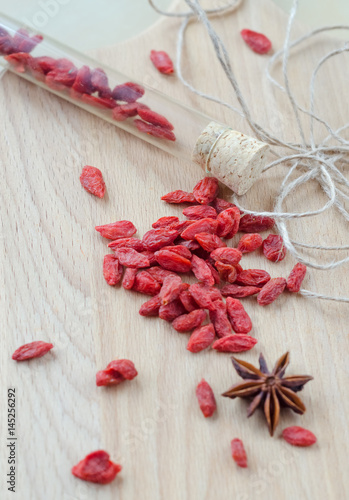 Goji berries and clove on a wooden Board.