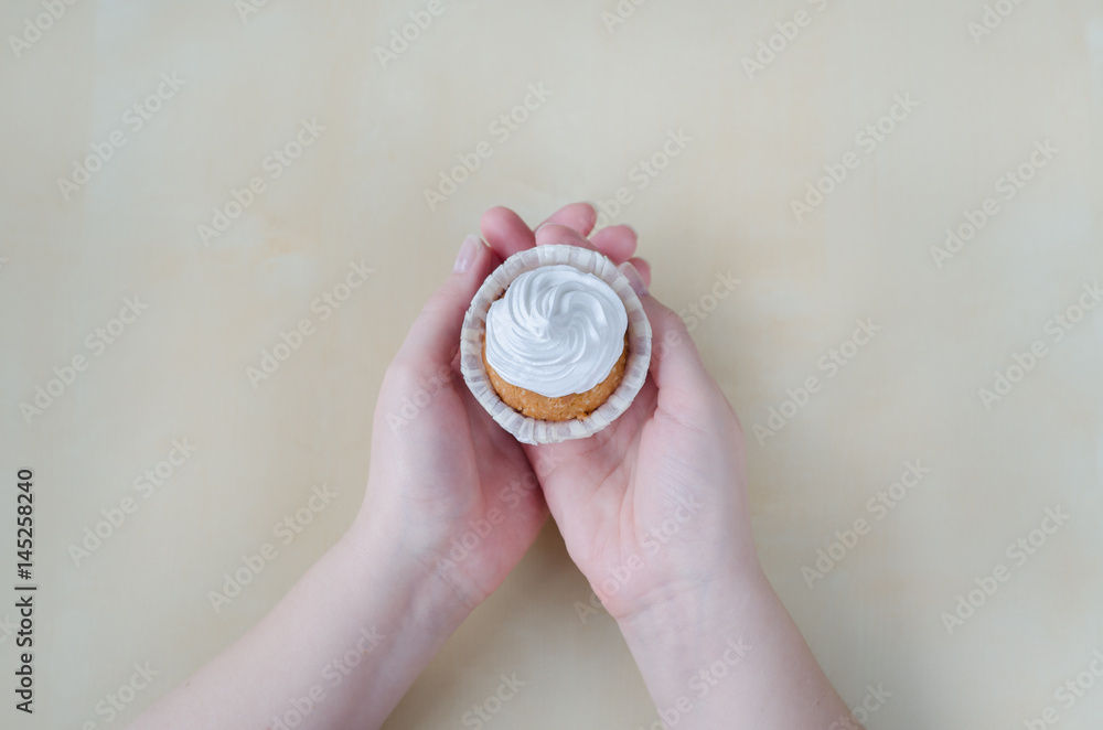 Cake with cream in woman hands
