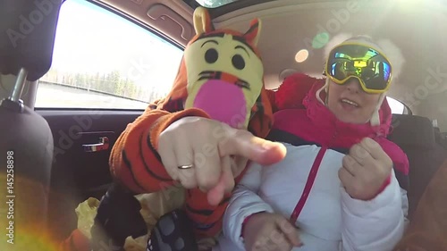 girl skier having fun with the music in the car on the trip