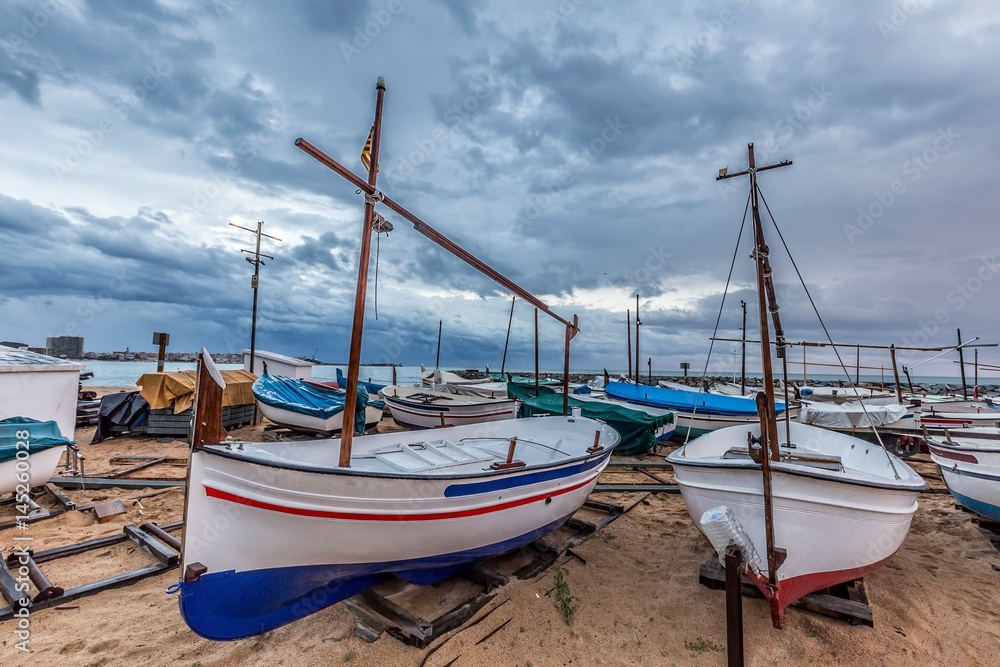 Small ficher boots on the beach in Palamos, Costa Brava in Spain