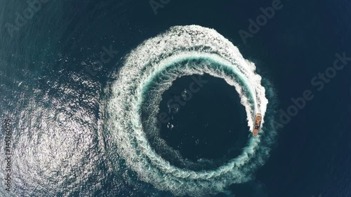 1333.Perpendicular aerial view of a maxi rib.Perpendicular aerial view of a maxi rib designing a circle in the sea navigating fast. photo