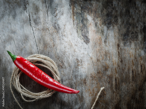 Red chillies on aged wood background