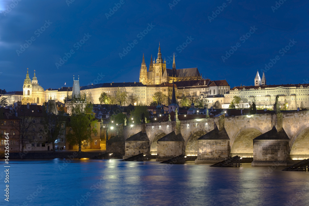 Prague night. Vltava river, old castle and Charles Bridge