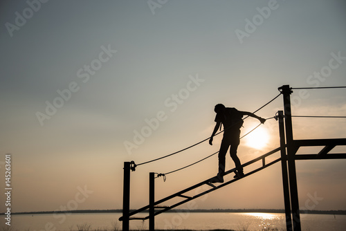 Adventure man climbing during sunset time