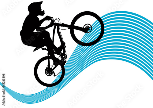 Silhouette of a biker descending on a mountain bike on a slope