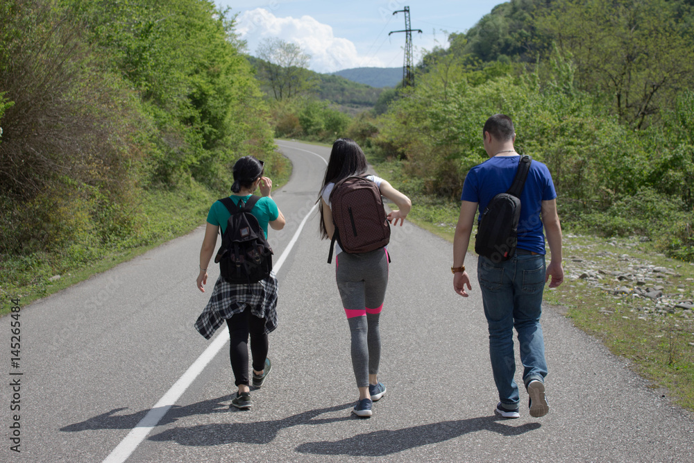 Travelers travel on the road in mountains go trekking together Travelers travel on the road in mountains go trekking together