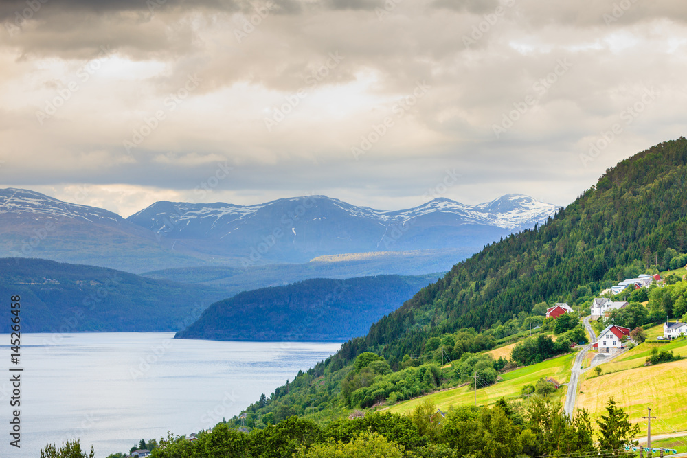 Norwegian country houses in the mountains on lake shore
