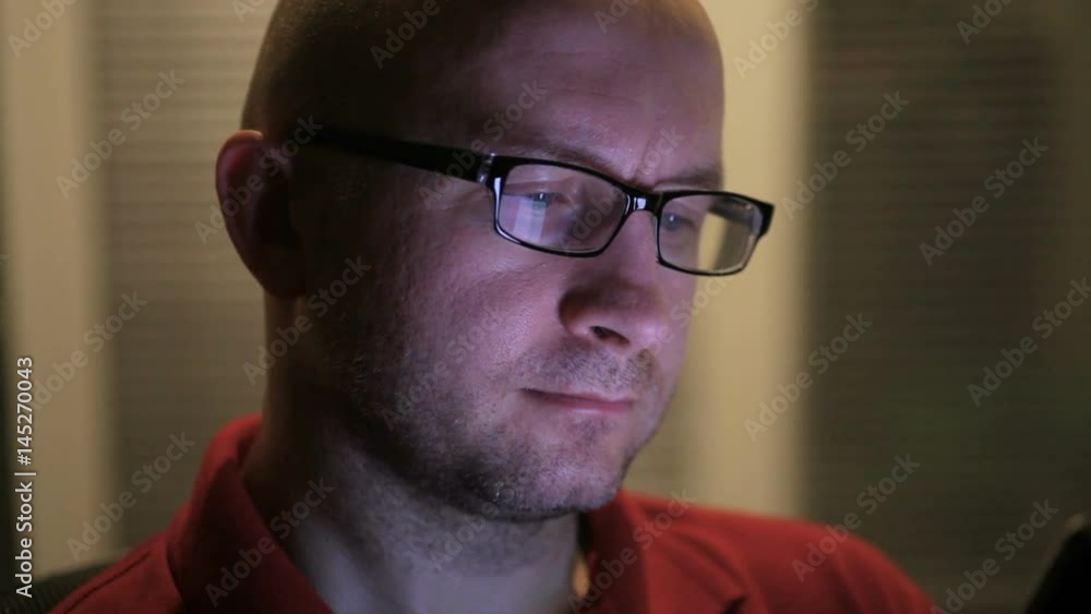 man in glasses sits with a tablet in his hands at the office man in glasses sits with a tablet in his hands at the office