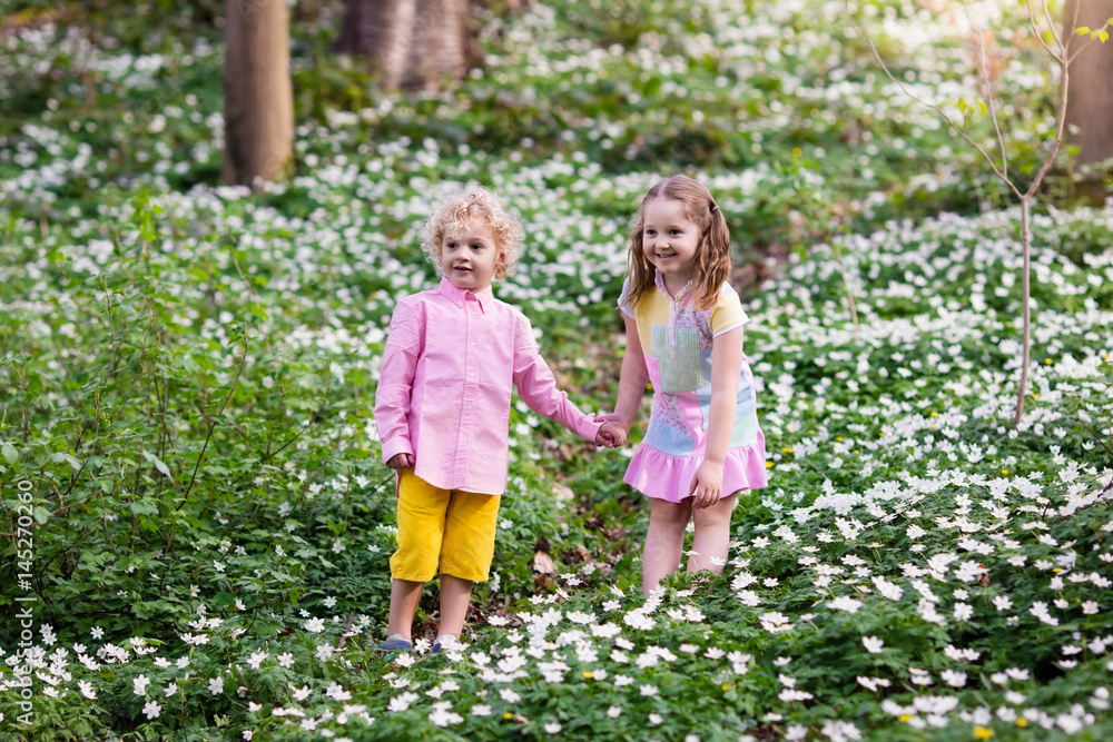 Children in spring park with flowers Children in spring park with flowers