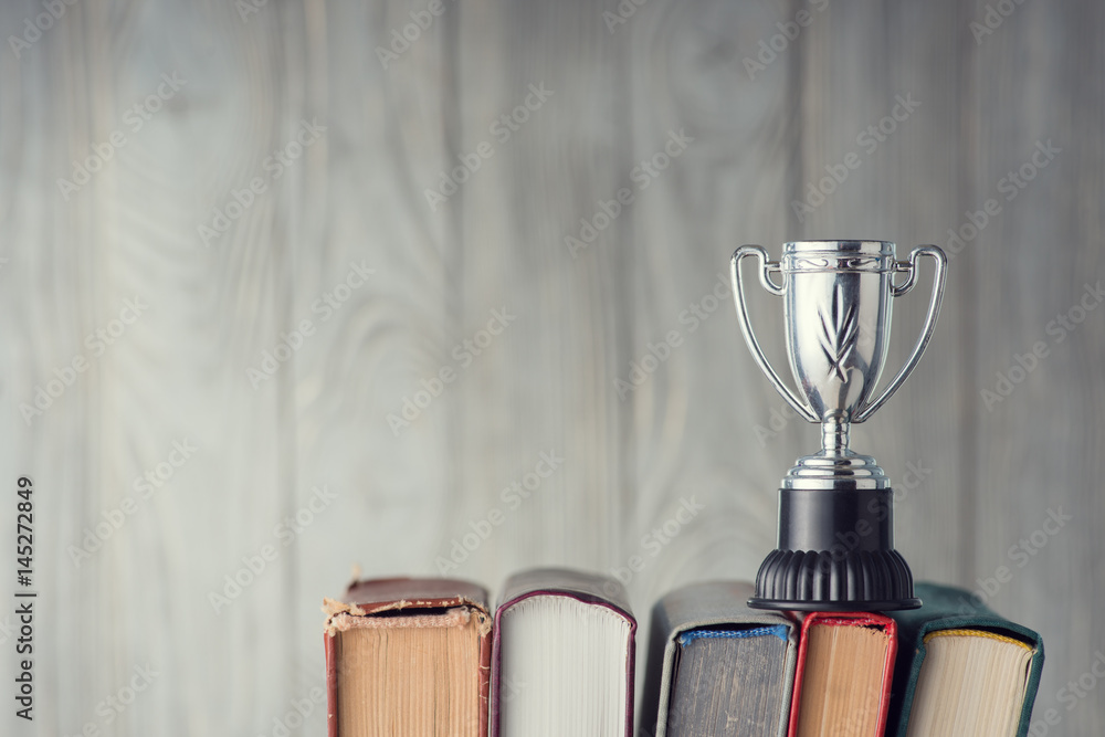 Fototapeta premium Books and sports cup