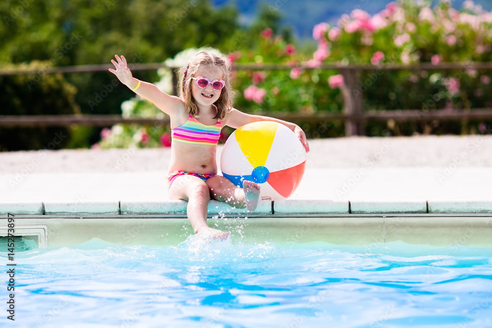 Child in swimming pool on summer vacation