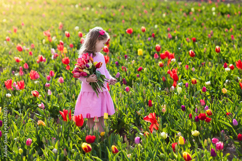Little girl in tulip flower garden #145276055