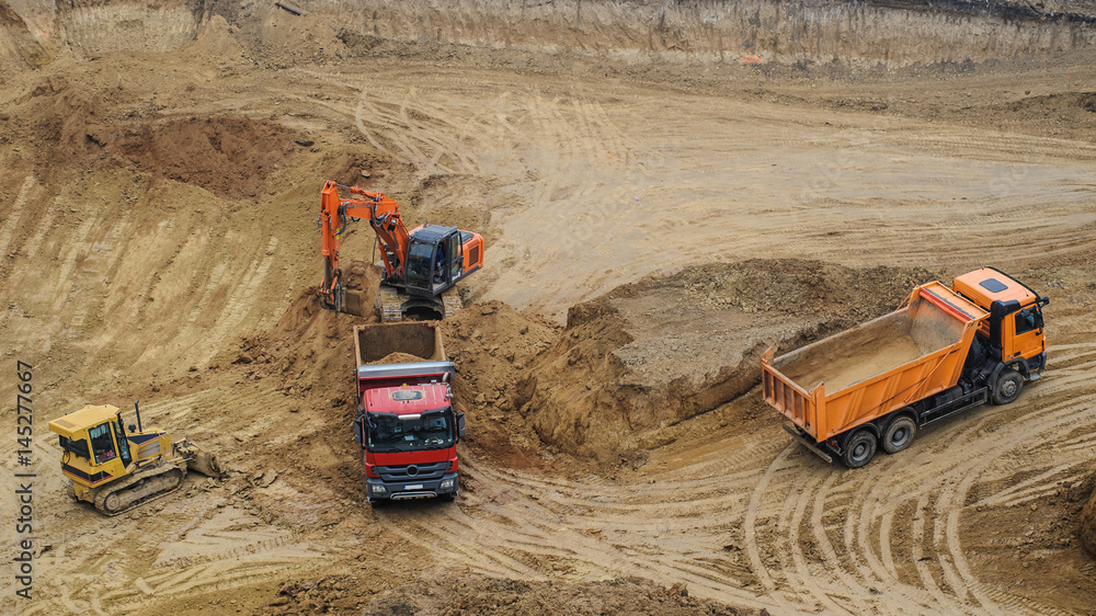 excavator moving earth and unloading into a dumper truck excavator moving earth and unloading into a dumper truck