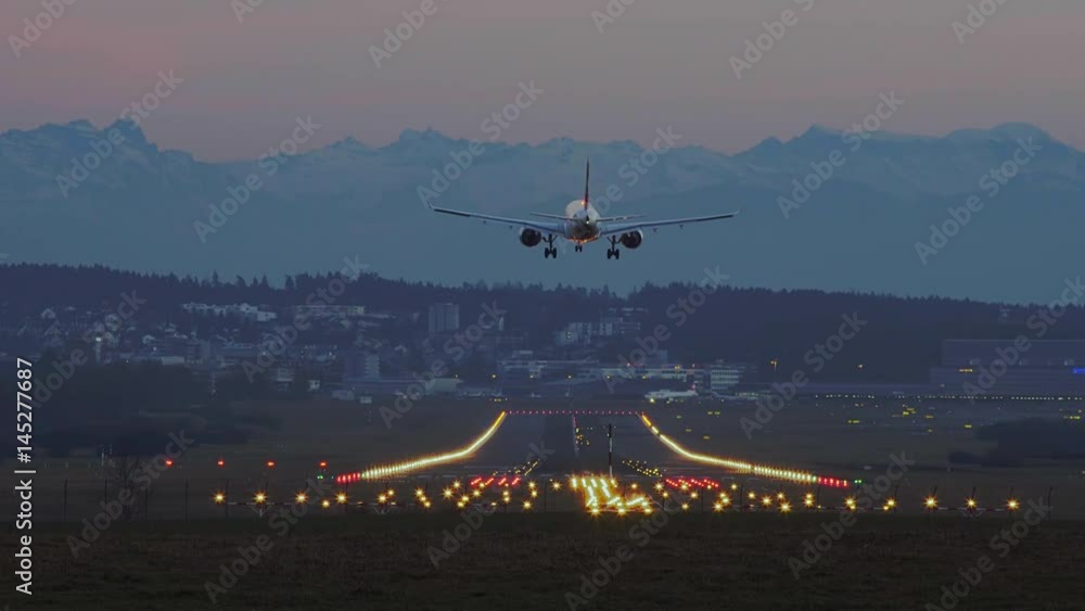Airplane Landing At Zurich Airport At Sunset