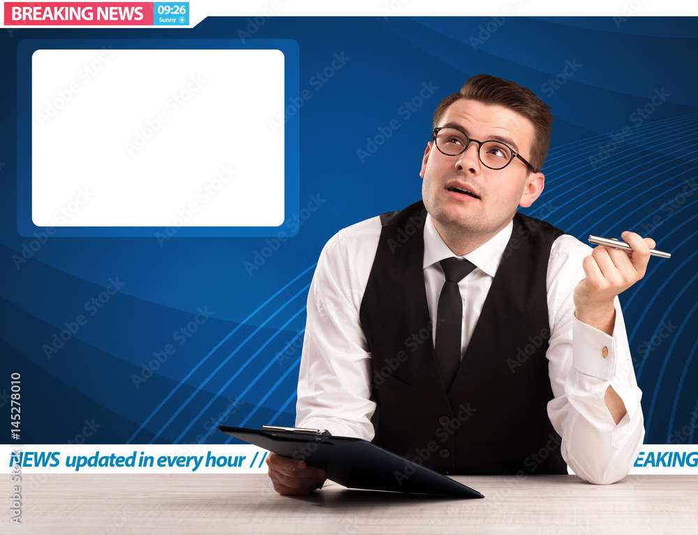 Television reporter telling breaking news at his studio desk with copy space Television reporter telling breaking news at his studio desk with copy space
