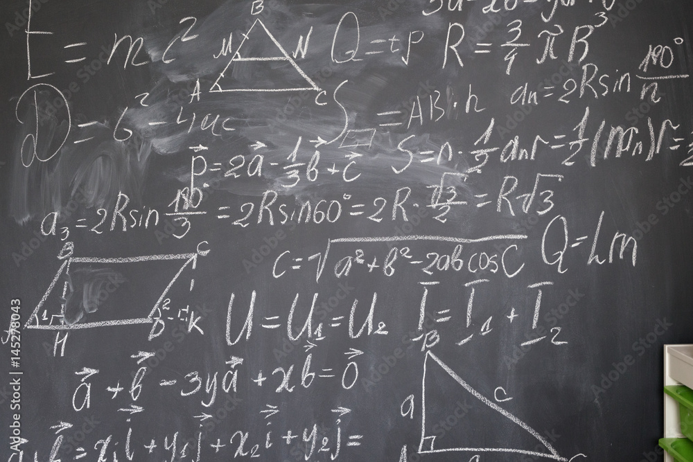 math formulas in white chalk on black board math formulas in white chalk on black board