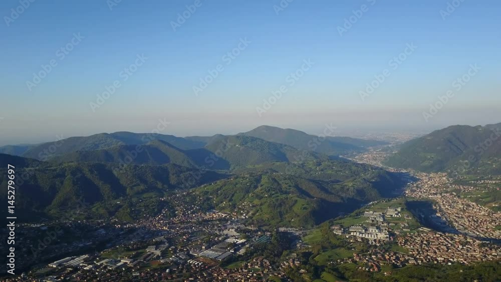 4K Drone aerial view to the Seriana valley and Orobie Alps in a clear and blue day. View of the highest mountains including Arera. Panorama from Farno Mountain, Bergamo, Italy. 4K Drone aerial view to the Seriana valley and Orobie Alps in a clear and blue day. View of the highest mountains including Arera. Panorama from Farno Mountain, Bergamo, Italy.
