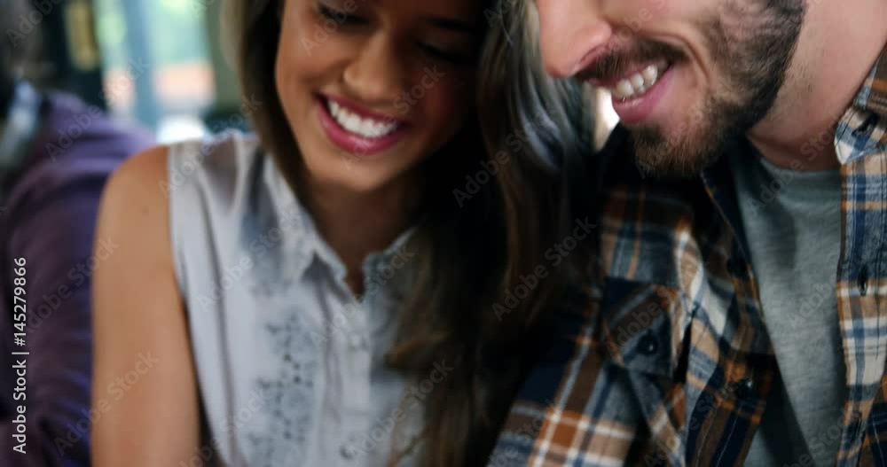 Couple using digital tablet and interacting with each other Couple using digital tablet and interacting with each other