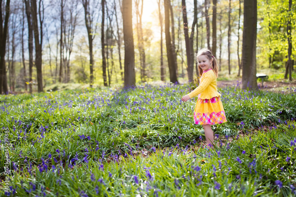 Child with bluebell flowers in spring forest Child with bluebell flowers in spring forest