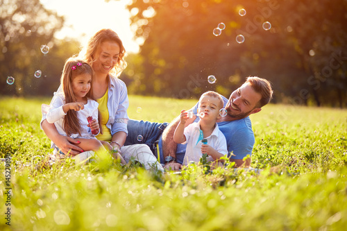 Fotografie Children enjoying in making soap bubbles