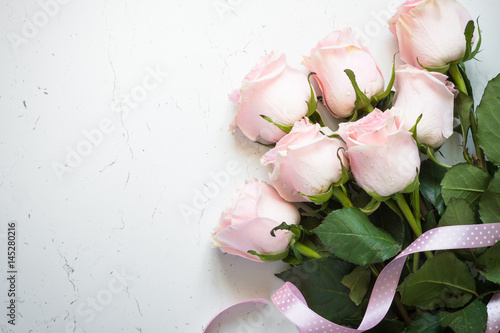 Pink rose at white stone table. Top view. photo