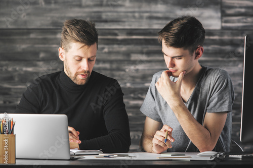 Young men doing paperwork photo