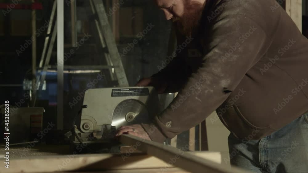 Carpenter Cutting Through Lumber with Compound Miter Saw Carpenter Cutting Through Lumber with Compound Miter Saw