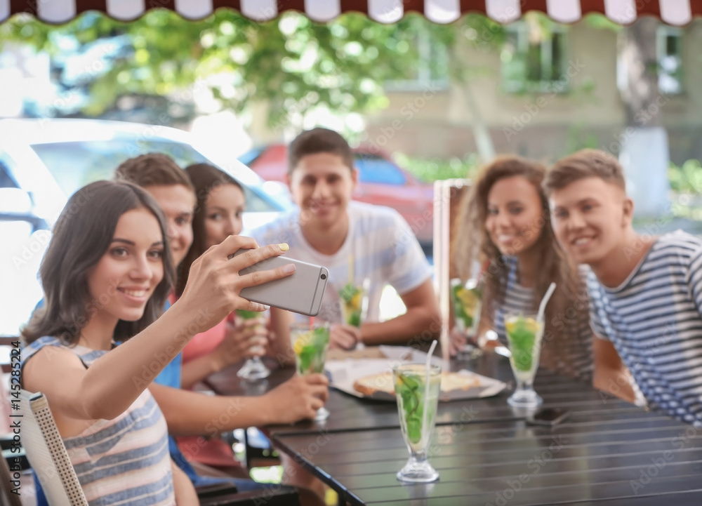 Happy friends taking selfie in cafe Happy friends taking selfie in cafe
