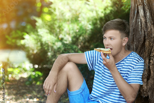 Handsome guy eating pizza o...