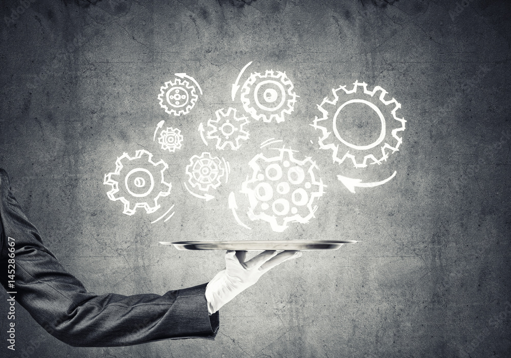 Waiter hand with empty silver tray and drawn gears concept Waiter hand with empty silver tray and drawn gears concept