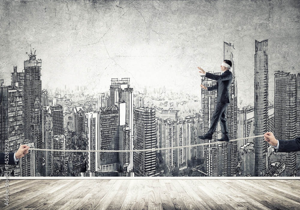 Obraz premium Business concept of risk support and assistance with man balancing on rope
