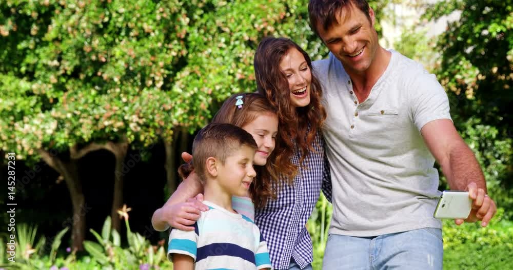 Happy family taking a selfie on mobile phone Happy family taking a selfie on mobile phone