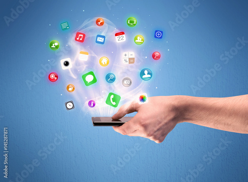 Hand holding tablet phone with app icons