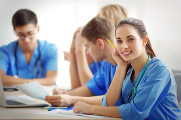 Group of medical students having lecture indoors