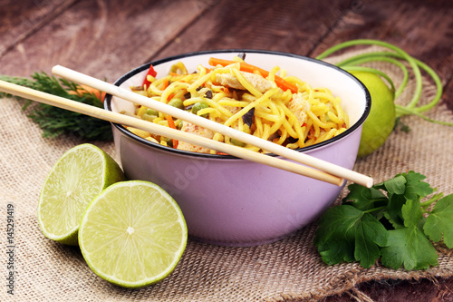 Traditional indonesian meal bami goreng with noodles, vegetables and chicken