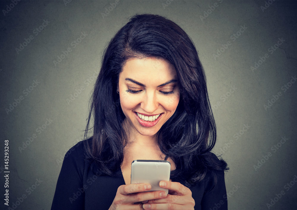 Laughing woman text messaging on smart phone having a pleasant chart conversation Laughing woman text messaging on smart phone having a pleasant chart conversation