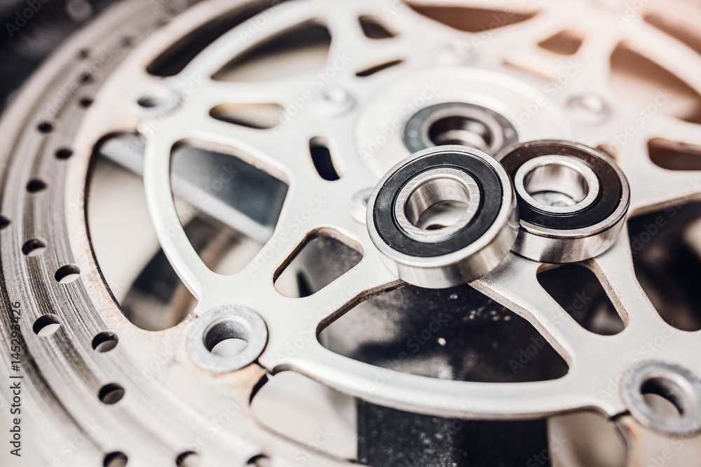 Naklejka premium Metal ball bearing on motorcycle disk brake.
