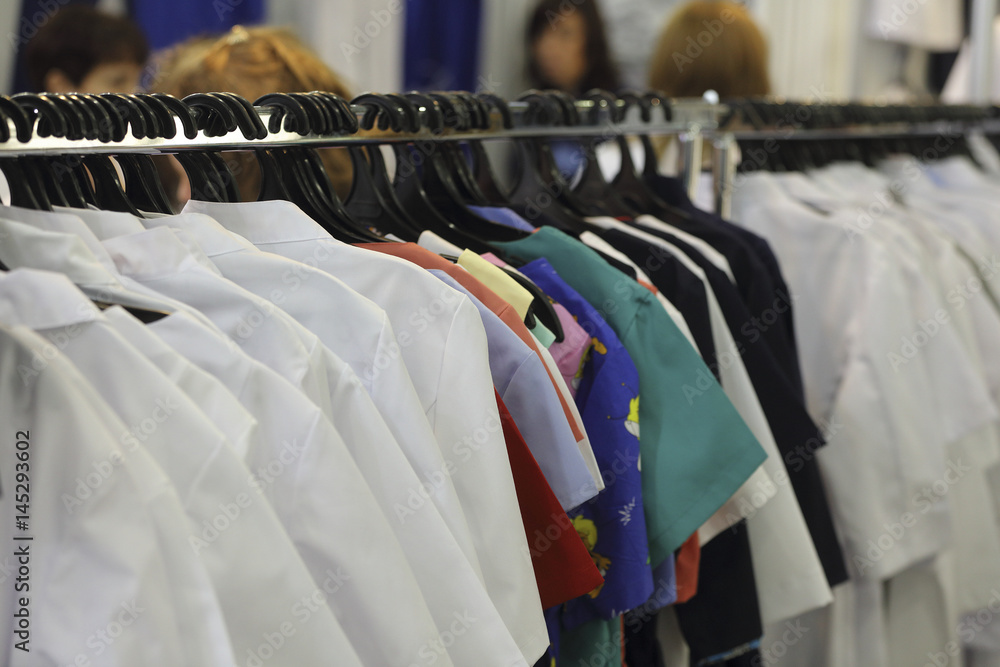 Fototapeta premium Medical uniform on a hangers in a shop